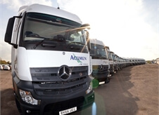 view of a large number of new Acumen Logistics lorries all lined up in a slight curve.